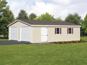 A two-car garage with a paved driveway surrounded by well-maintained landscaping.