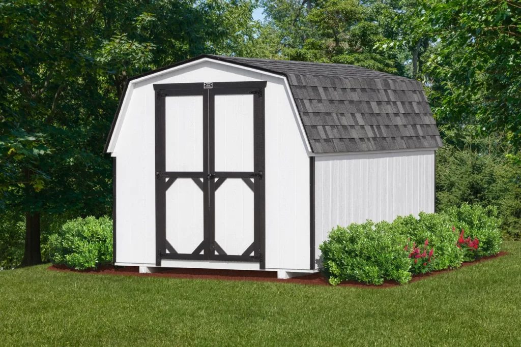 A shed featuring a black roof and white trim, set against a clear sky.