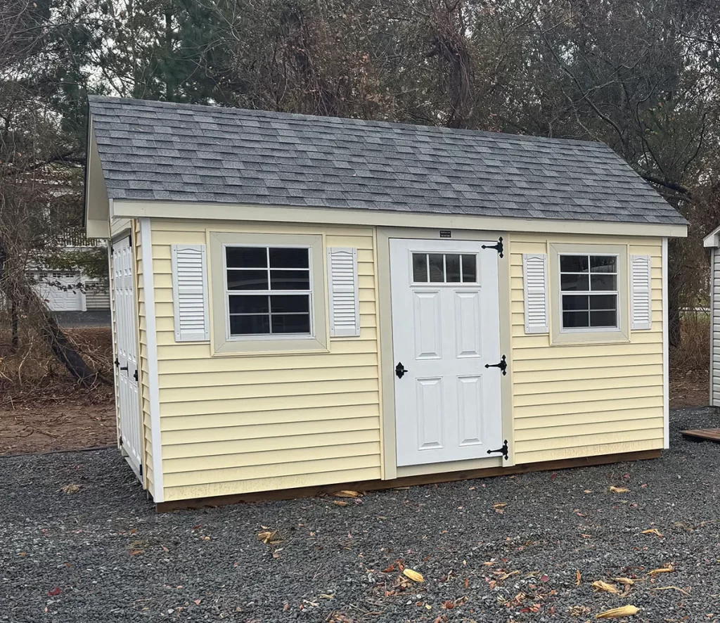 Small yellow shed with white trim.