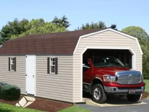 A red truck parked inside a spacious garage, with tools and equipment visible in the background.