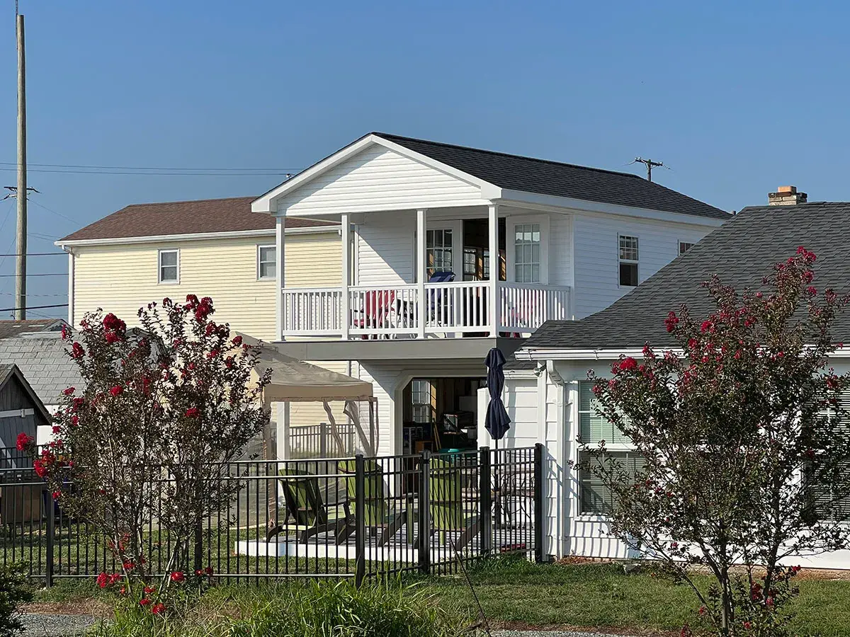 A house featuring a balcony and a porch, showcasing its inviting outdoor spaces.