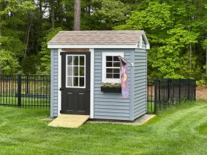 A small blue shed featuring a door and a window, set against a neutral background.